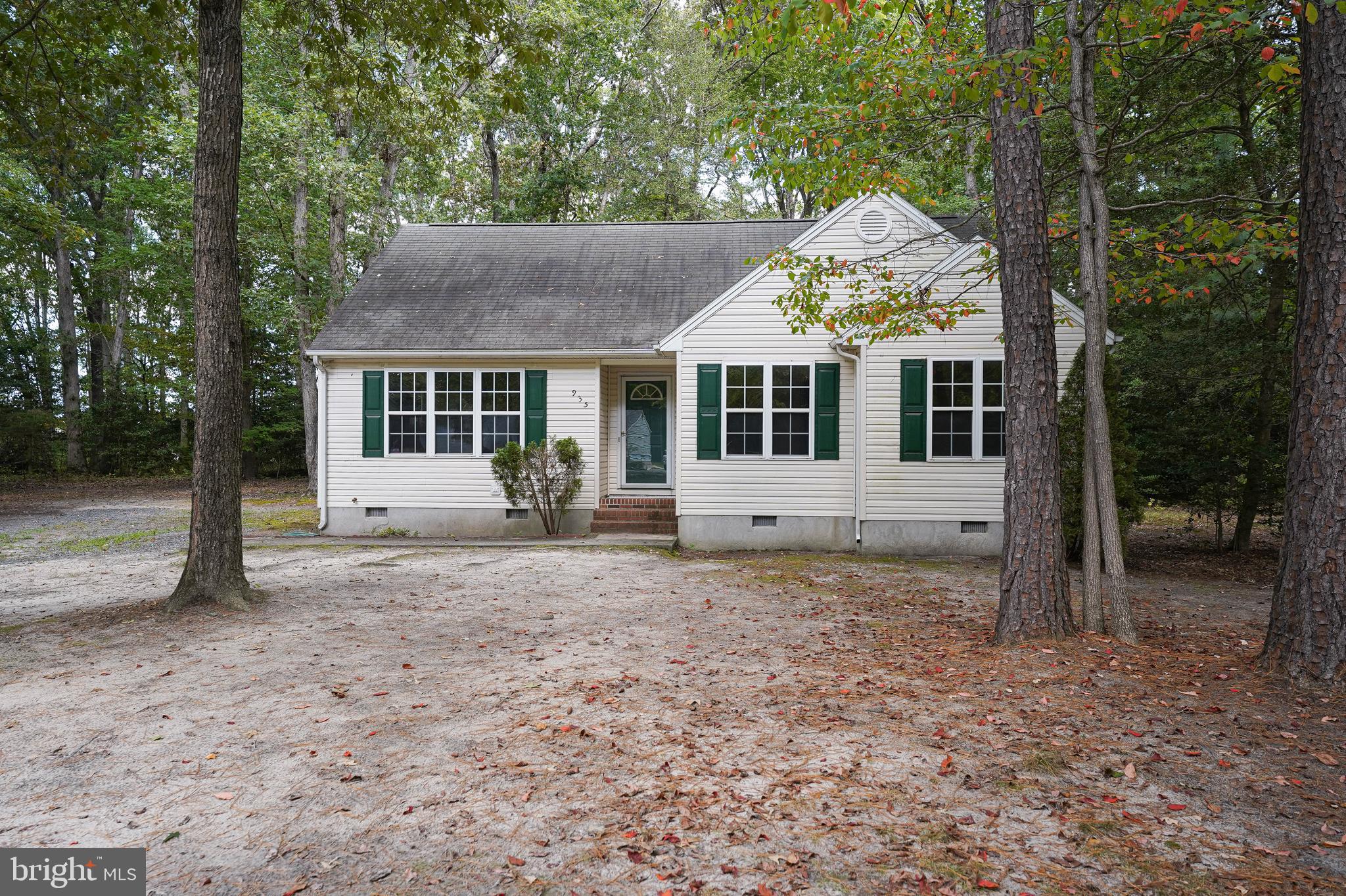 a view of a house with a yard and large tree