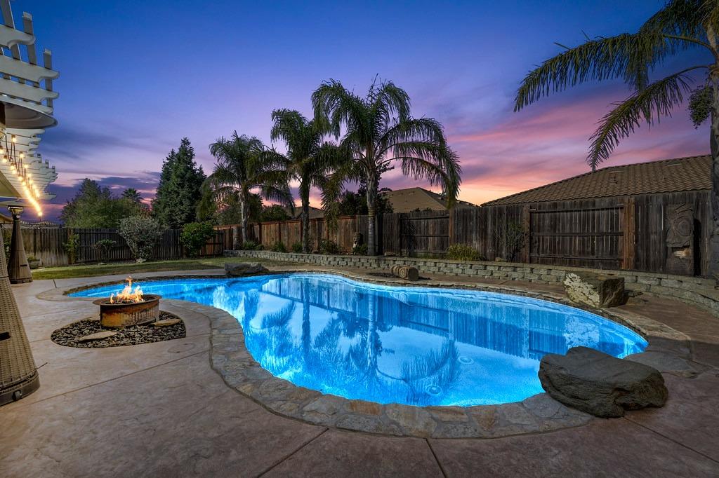 a view of a swimming pool with a lounge chair in the patio