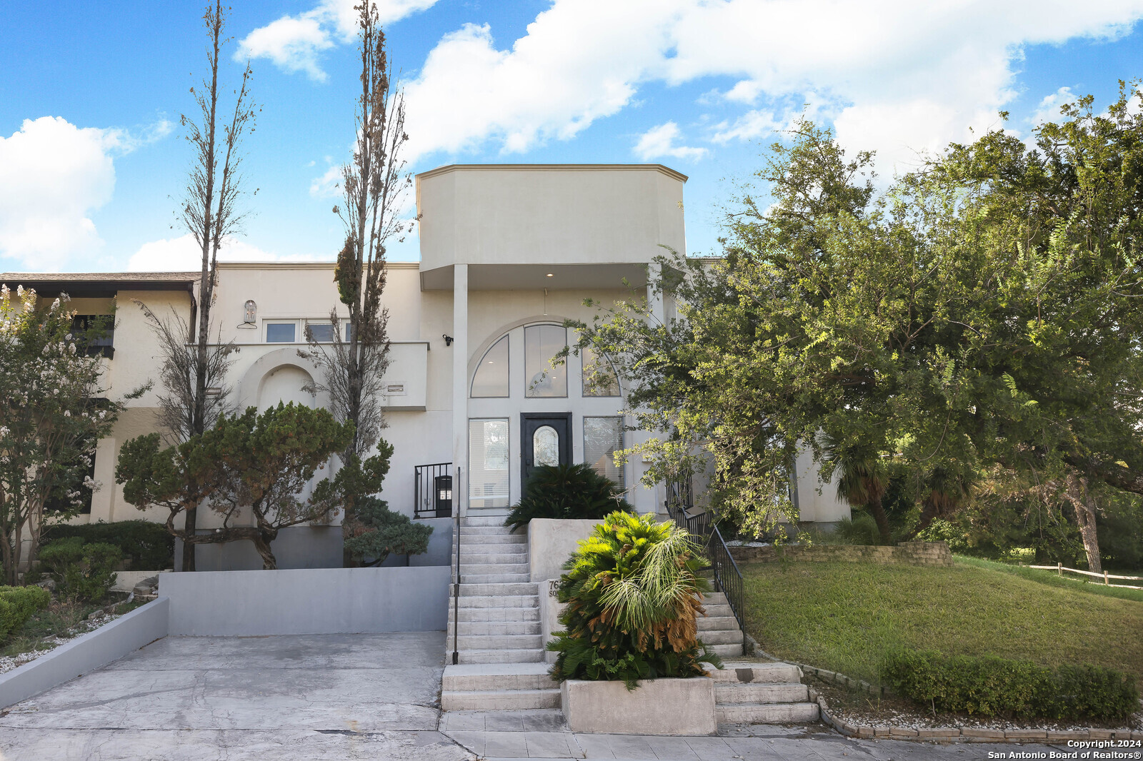 a front view of a building with garden