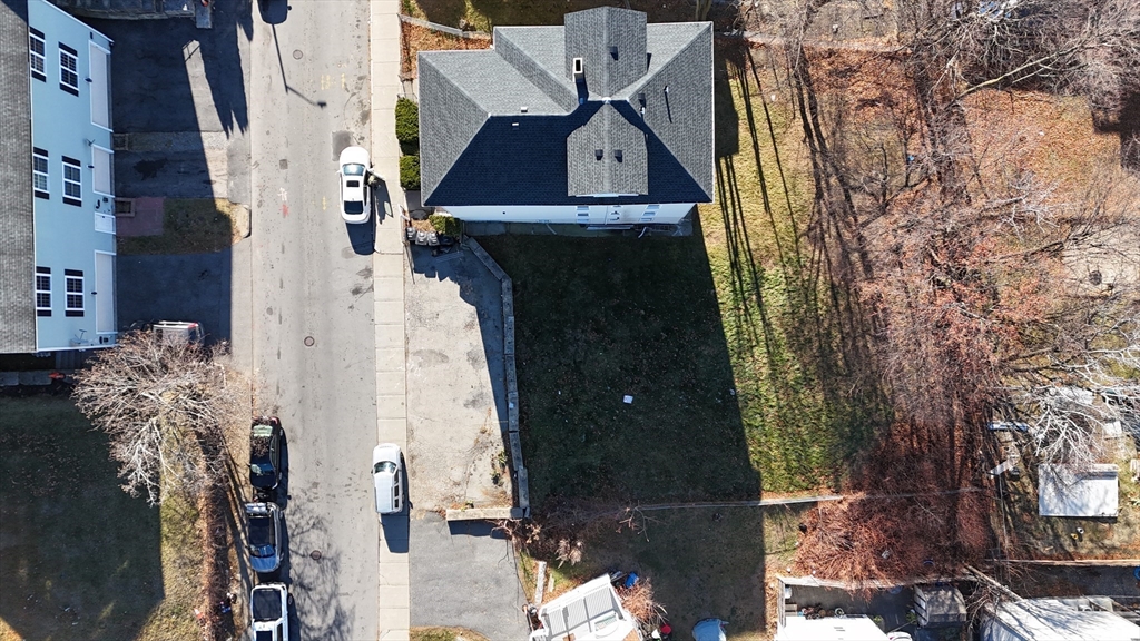 an aerial view of a house with a yard