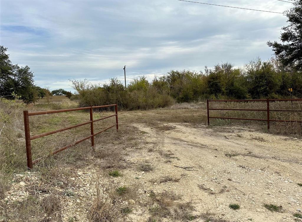 a view of a yard with wooden fence