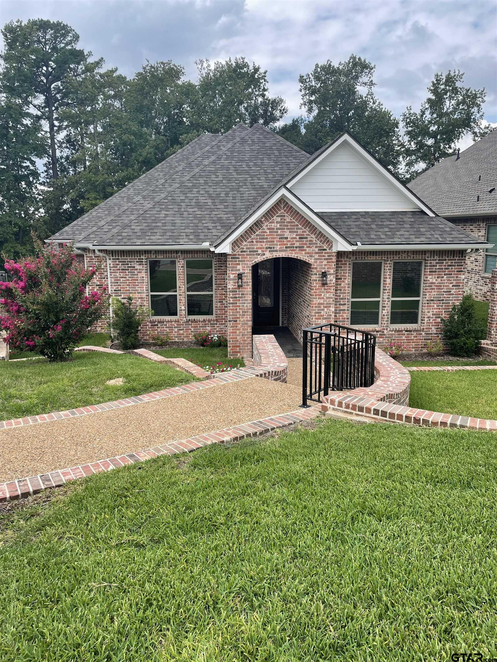 a front view of house with yard and green space