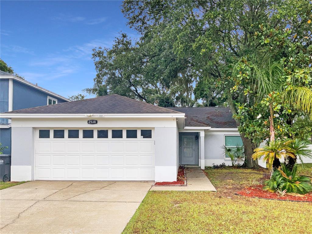 a front view of a house with a yard and garage