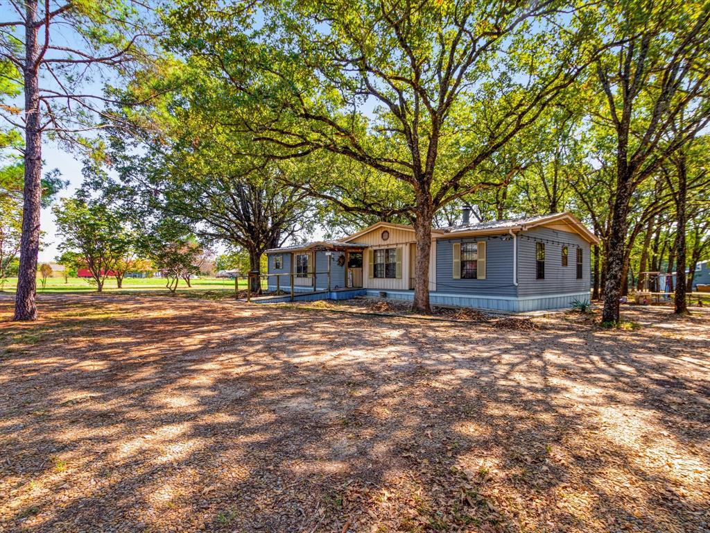 a view of a yard with a house and tree s