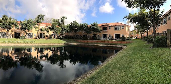 a view of a lake with a house in the background