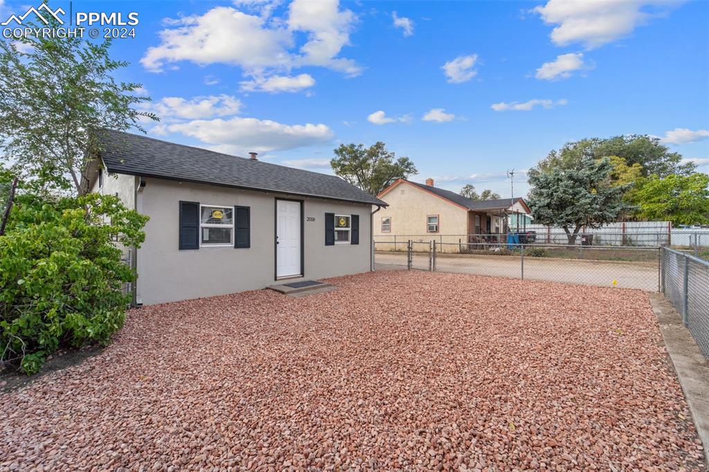 a road view with backyard of house