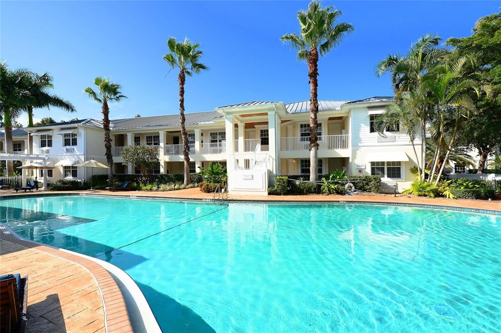 a front view of house with yard and swimming pool