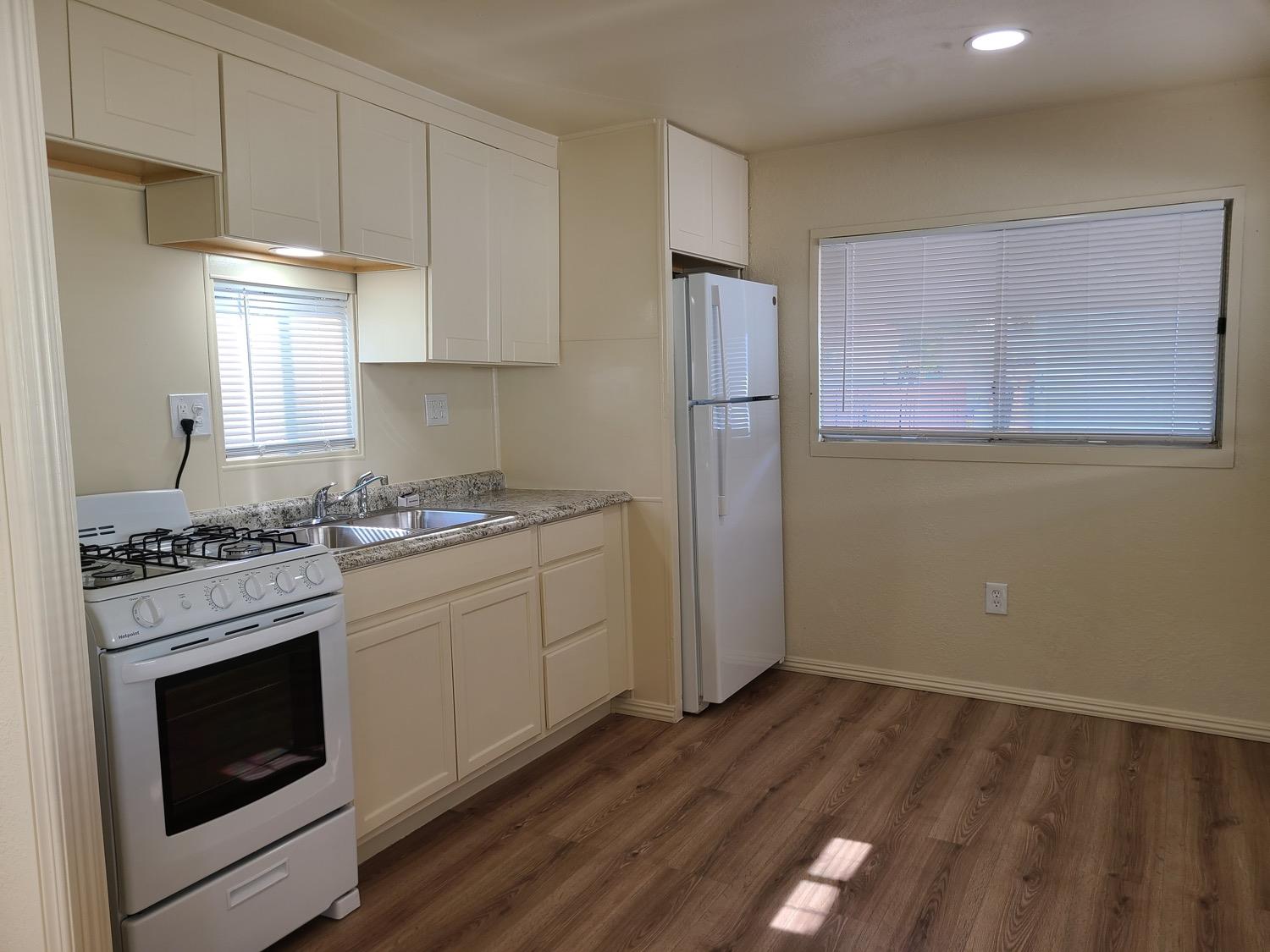 a kitchen with a stove a sink and a refrigerator