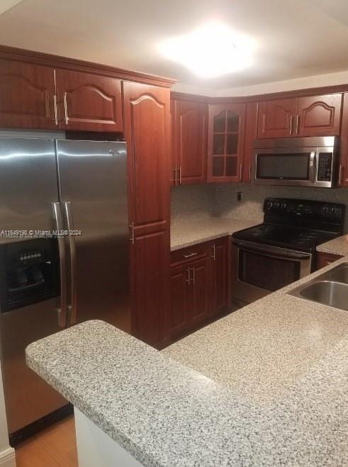 a kitchen with kitchen island a counter top space cabinets and stainless steel appliances