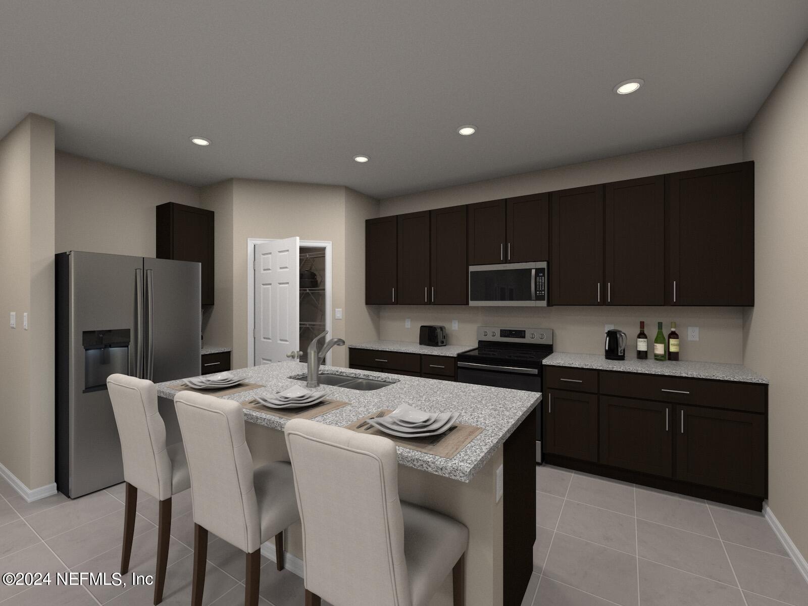 a kitchen with stainless steel appliances kitchen island granite countertop a stove a sink a refrigerator and a refrigerator