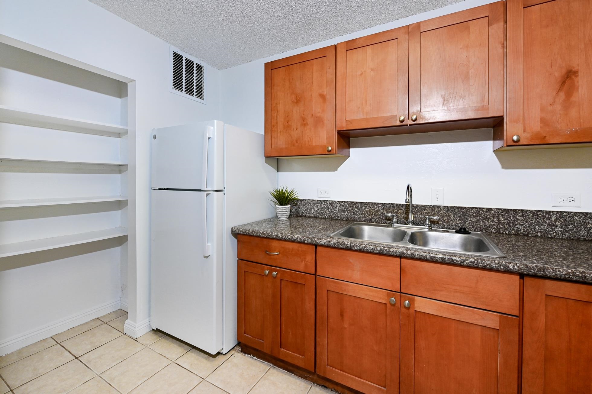 a kitchen with stainless steel appliances granite countertop a sink and a cabinets