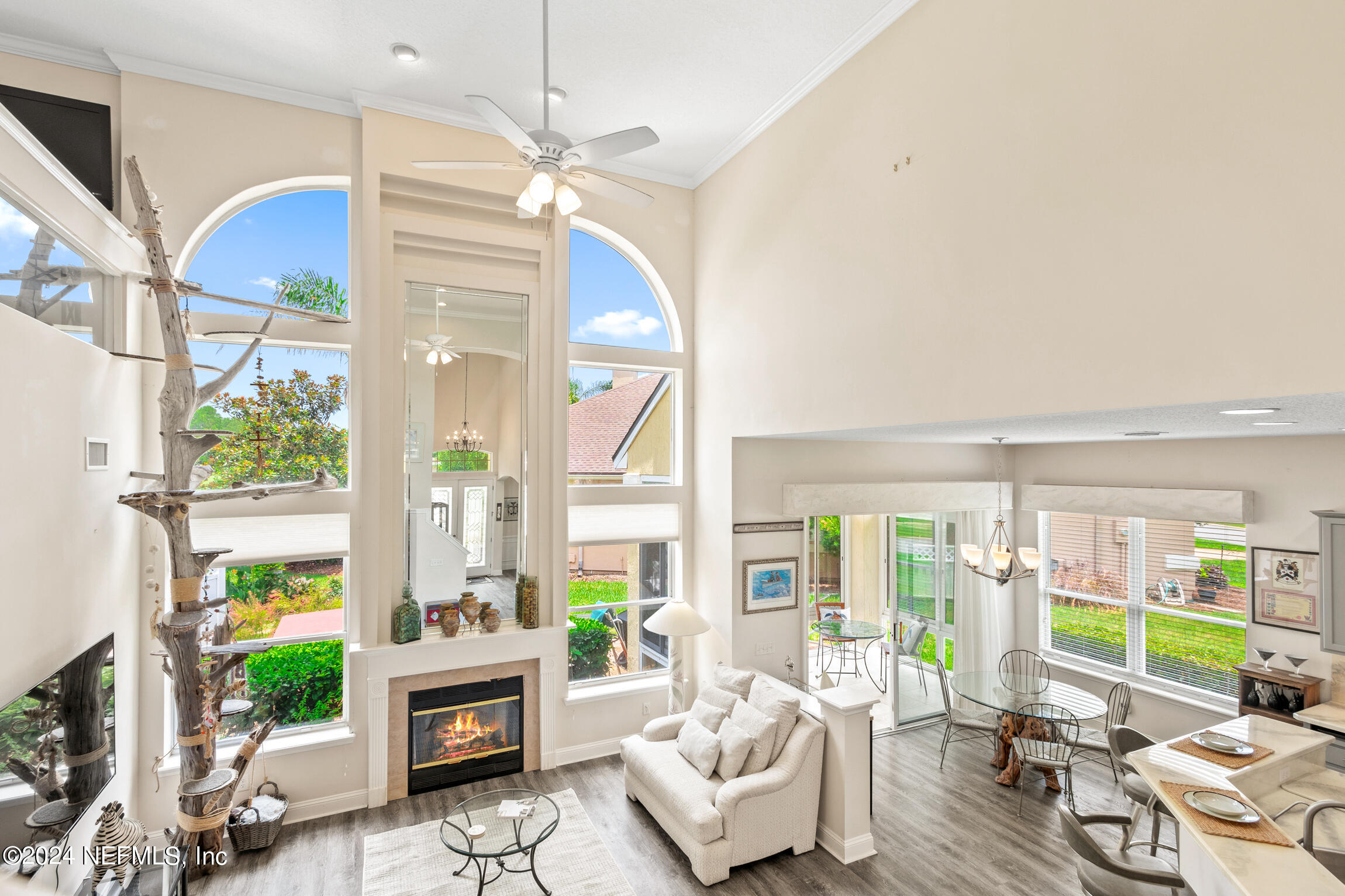 a living room with fireplace furniture and a large window