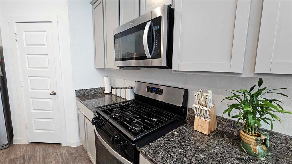 a kitchen with a stove and a microwave