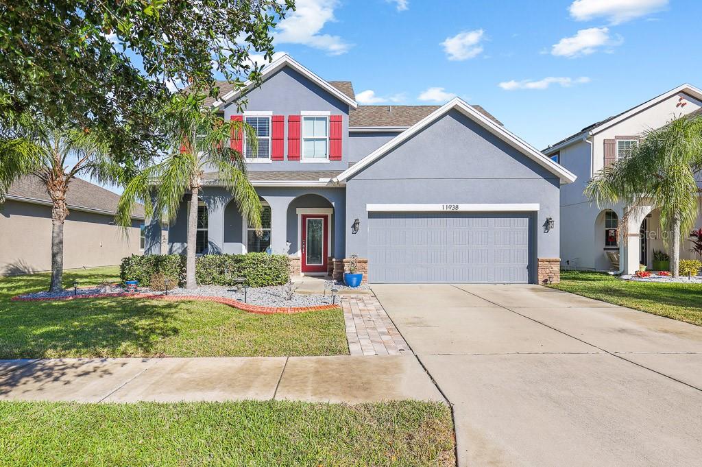 a front view of a house with a yard and garage