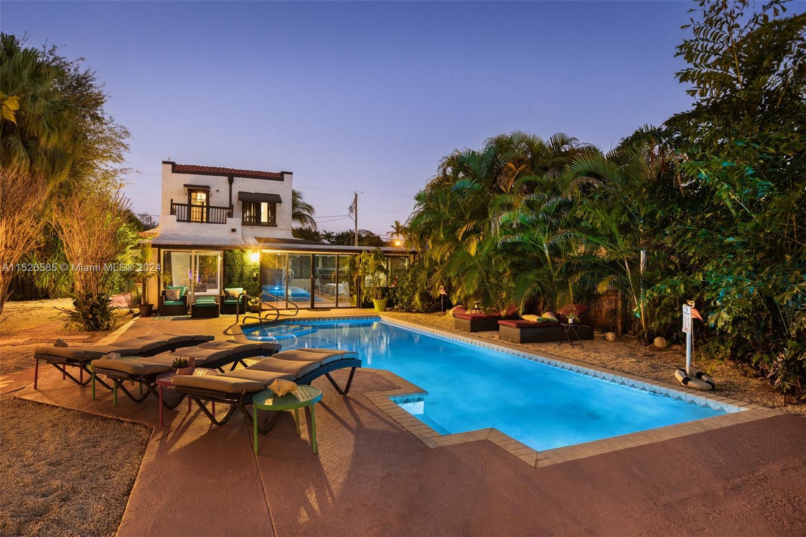 a view of a swimming pool with outdoor seating