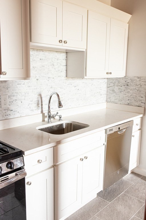 a kitchen with a sink cabinets and appliances