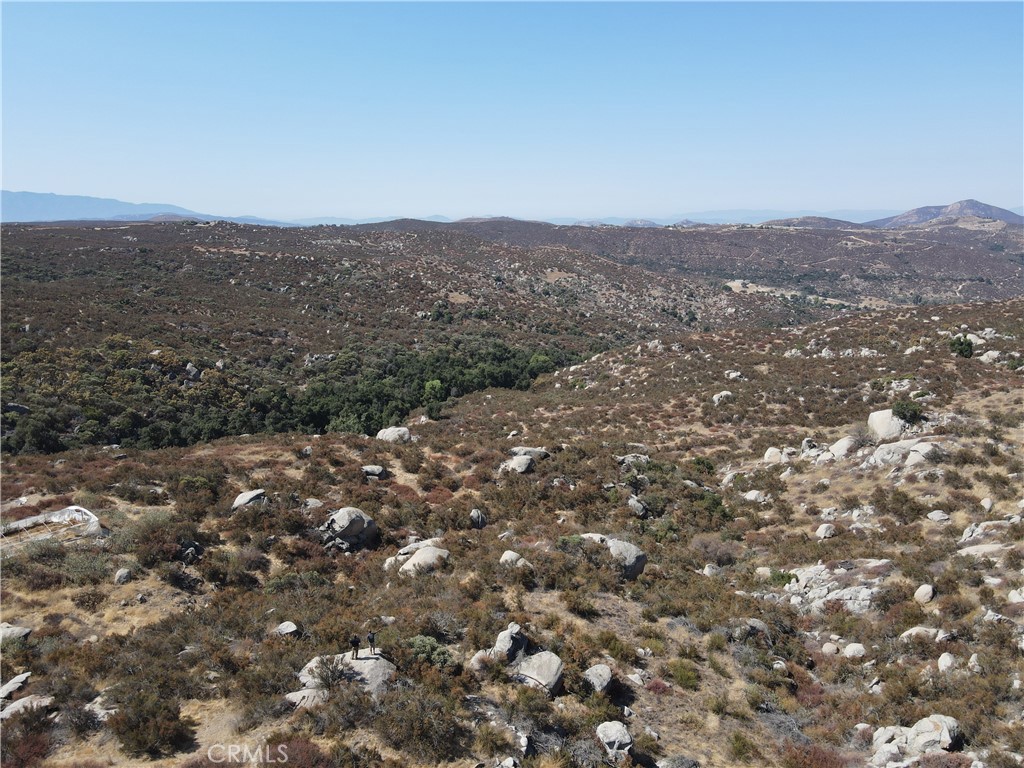 an aerial view of houses with yard and mountain view in back