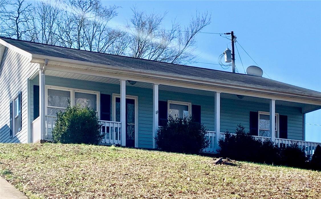 a view of a house with a flower garden