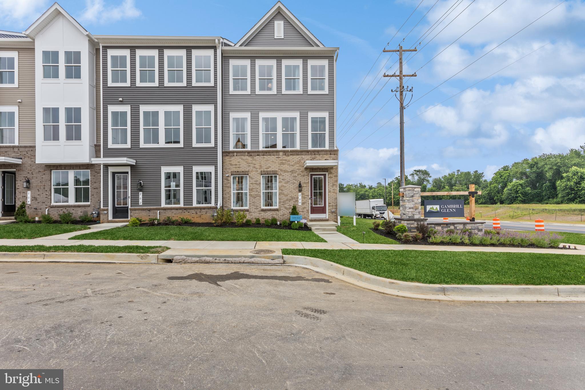 a front view of a residential apartment building with a yard