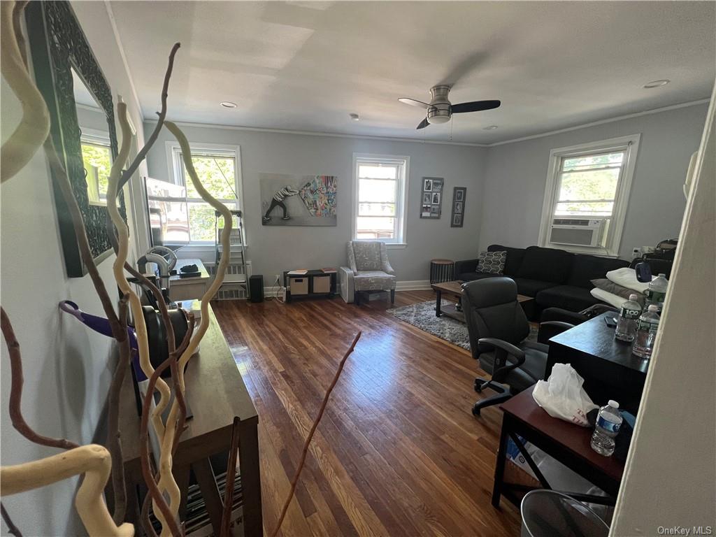 a living room with furniture fireplace and wooden floor