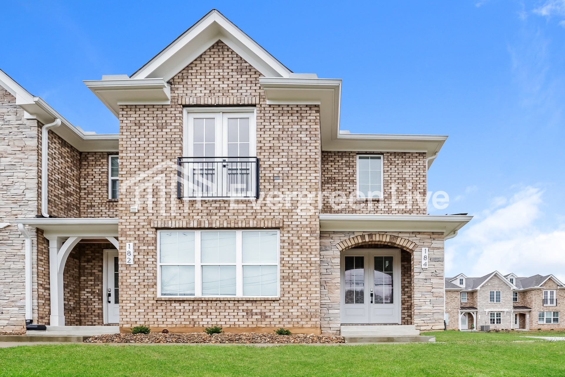 a front view of a house with a yard