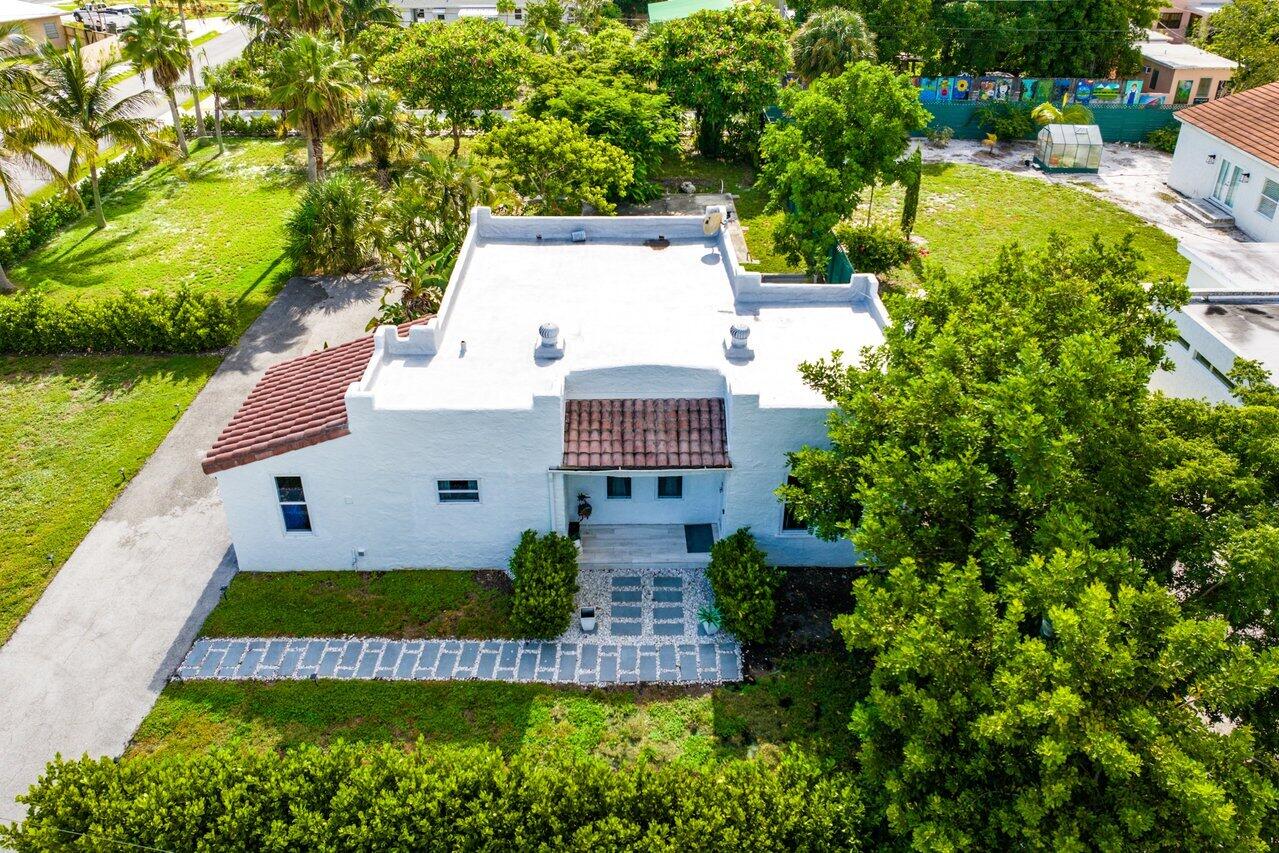 an aerial view of a house with a garden and swimming pool