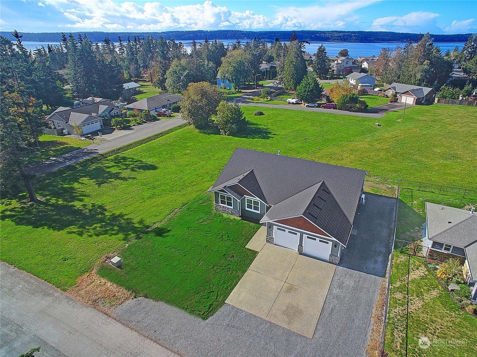 an aerial view of a house with a garden and lake view