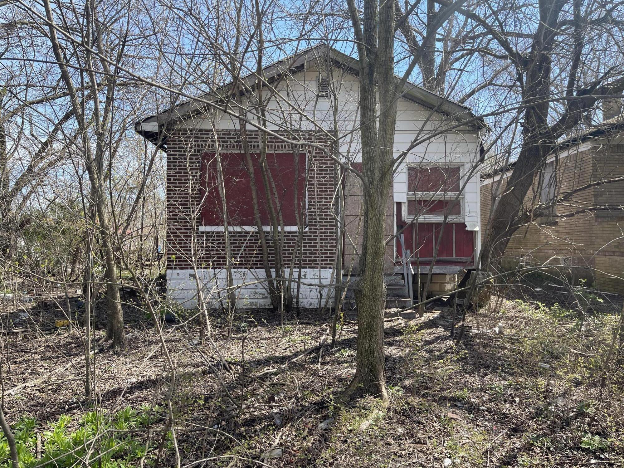 a view of a house with a yard and wooden fence