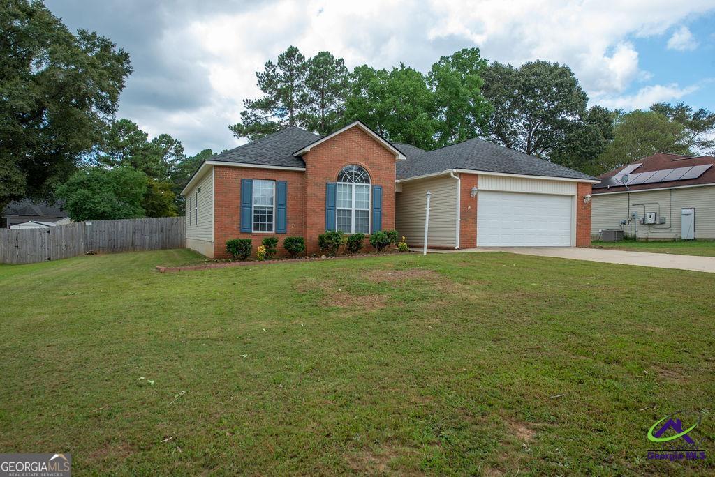 a front view of a house with yard and green space