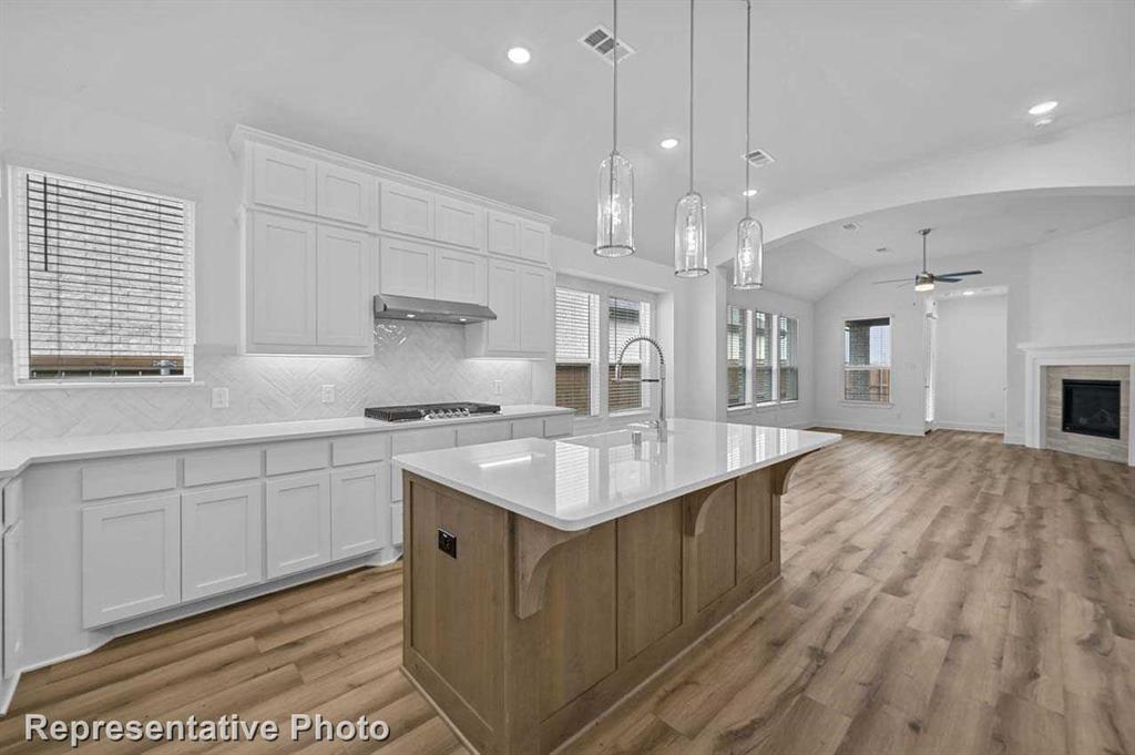 a kitchen with a sink stove and cabinets