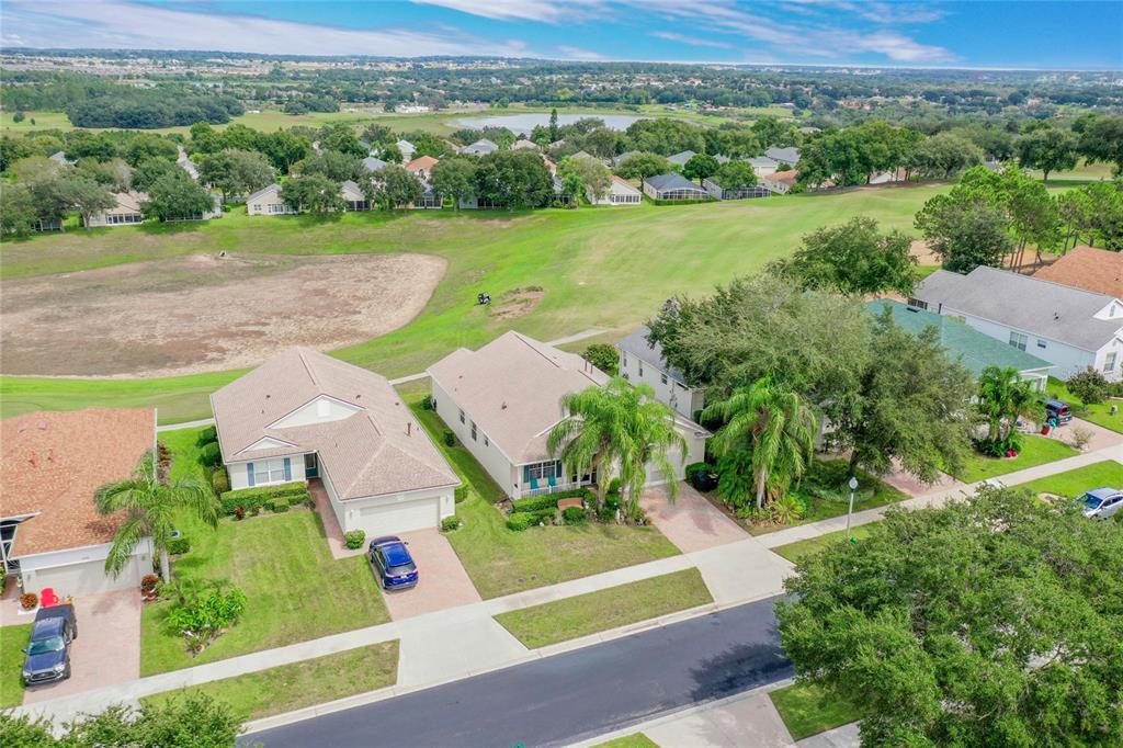 an aerial view of a house with garden space and street view