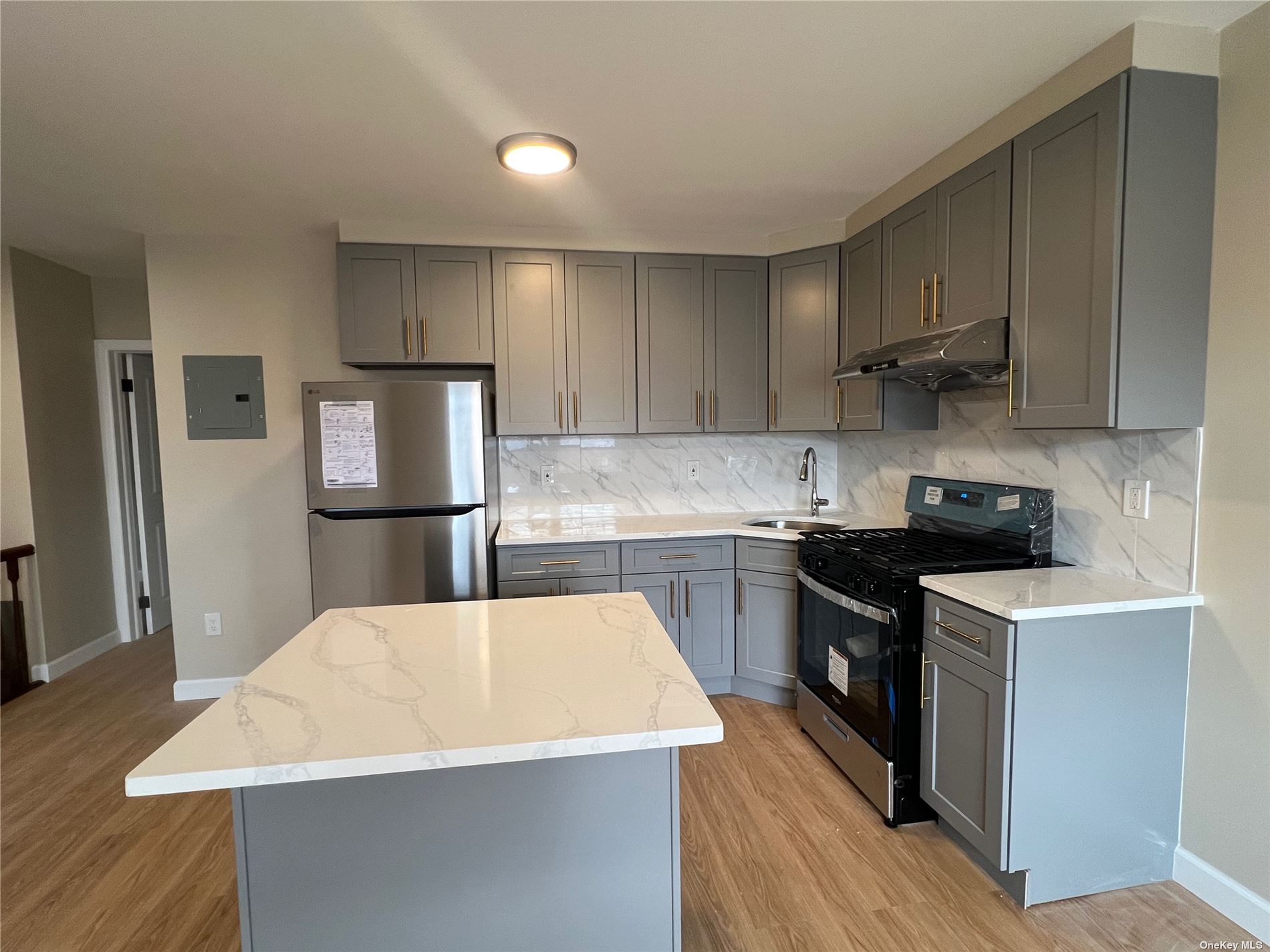 a kitchen with stainless steel appliances wooden floors and wooden cabinets