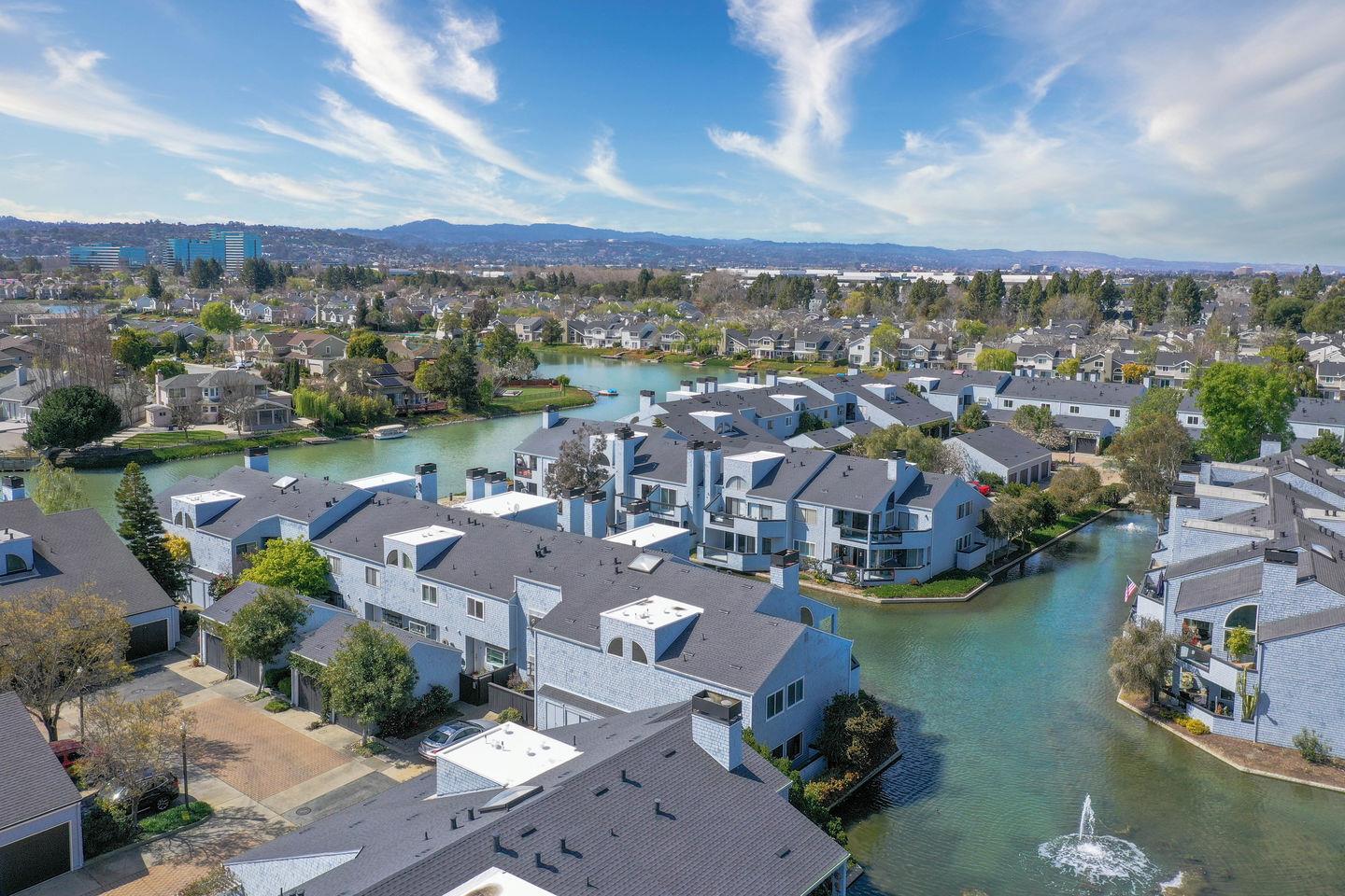 an aerial view of a city with lots of residential buildings lake and ocean view