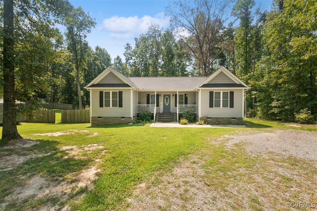 a front view of a house with yard and green space