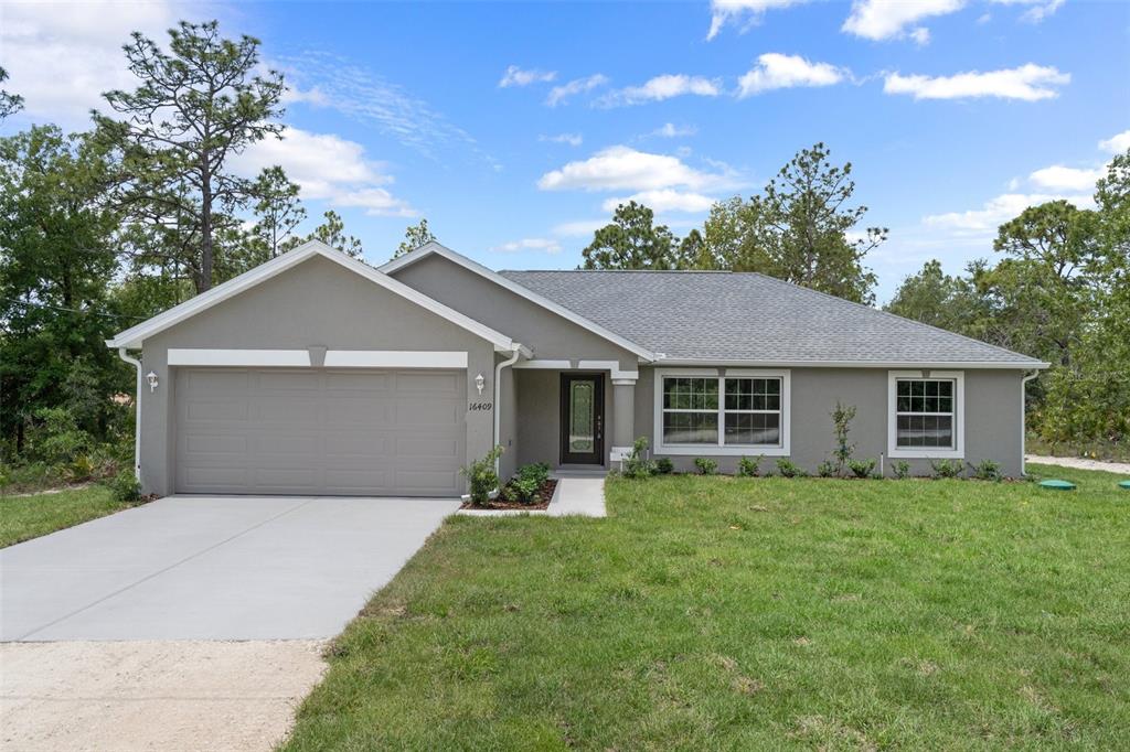 a front view of house with yard and trees