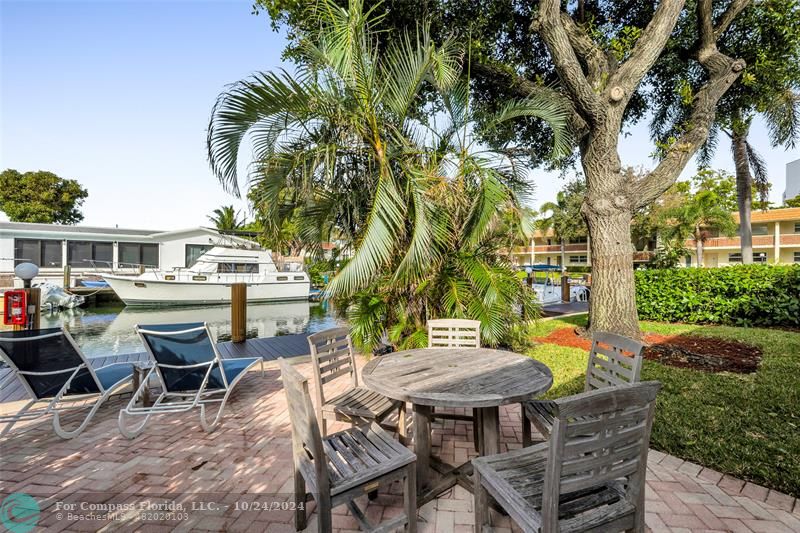 a backyard of a house with table and chairs