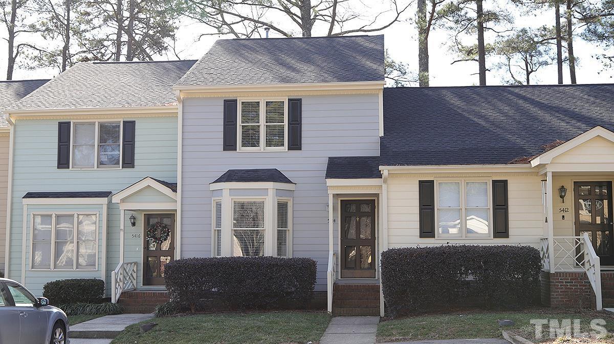 a front view of a house with outdoor seating