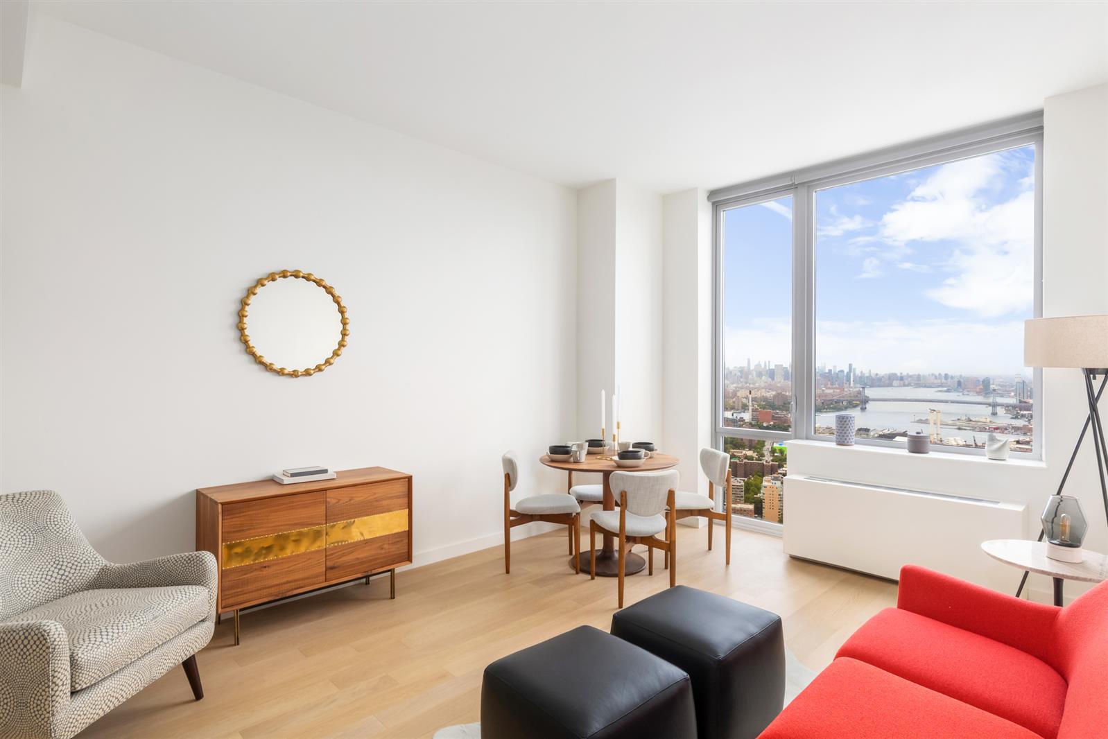 a living room with furniture a rug a lamp and a large window