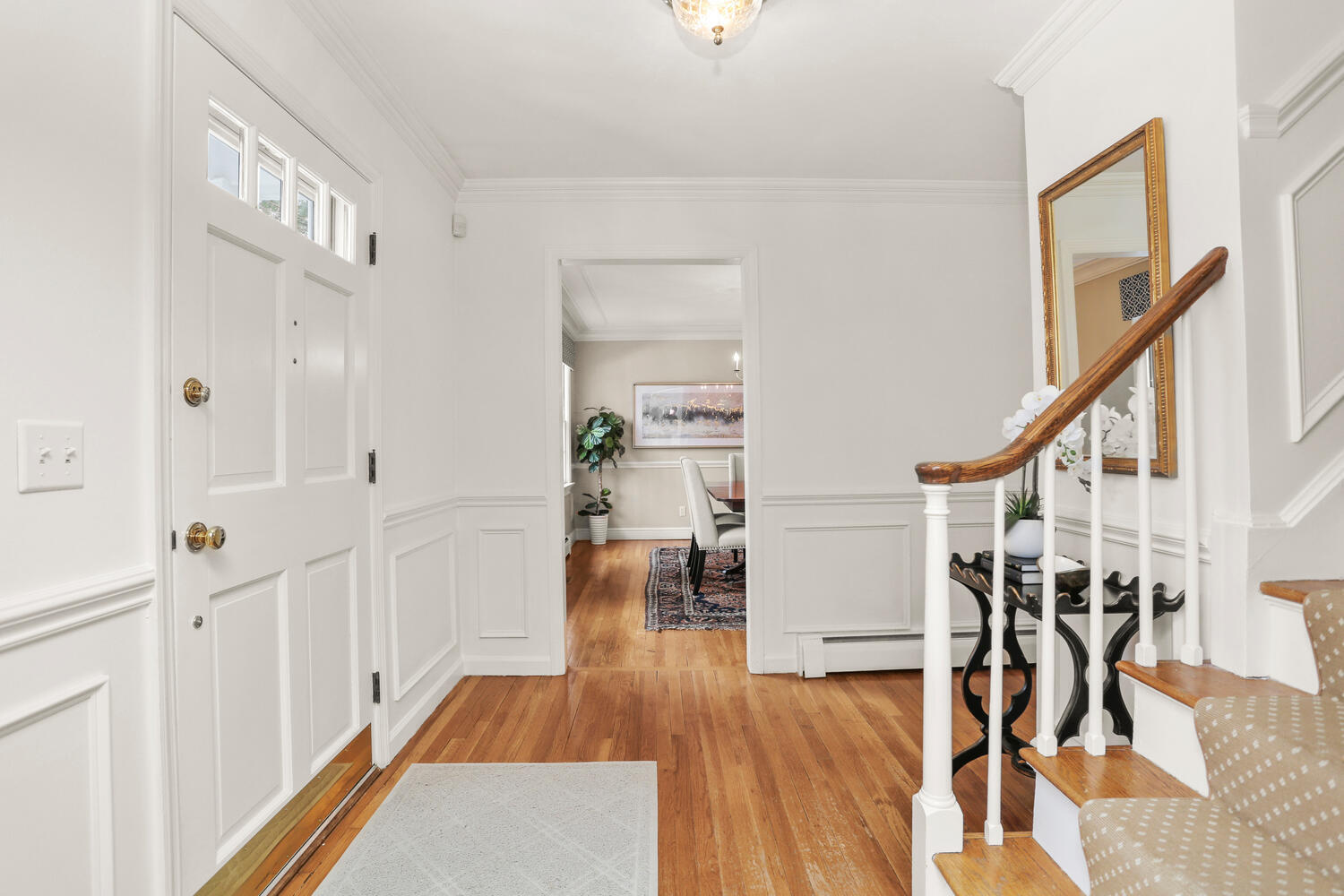 a view of entryway with wooden floor and stairs