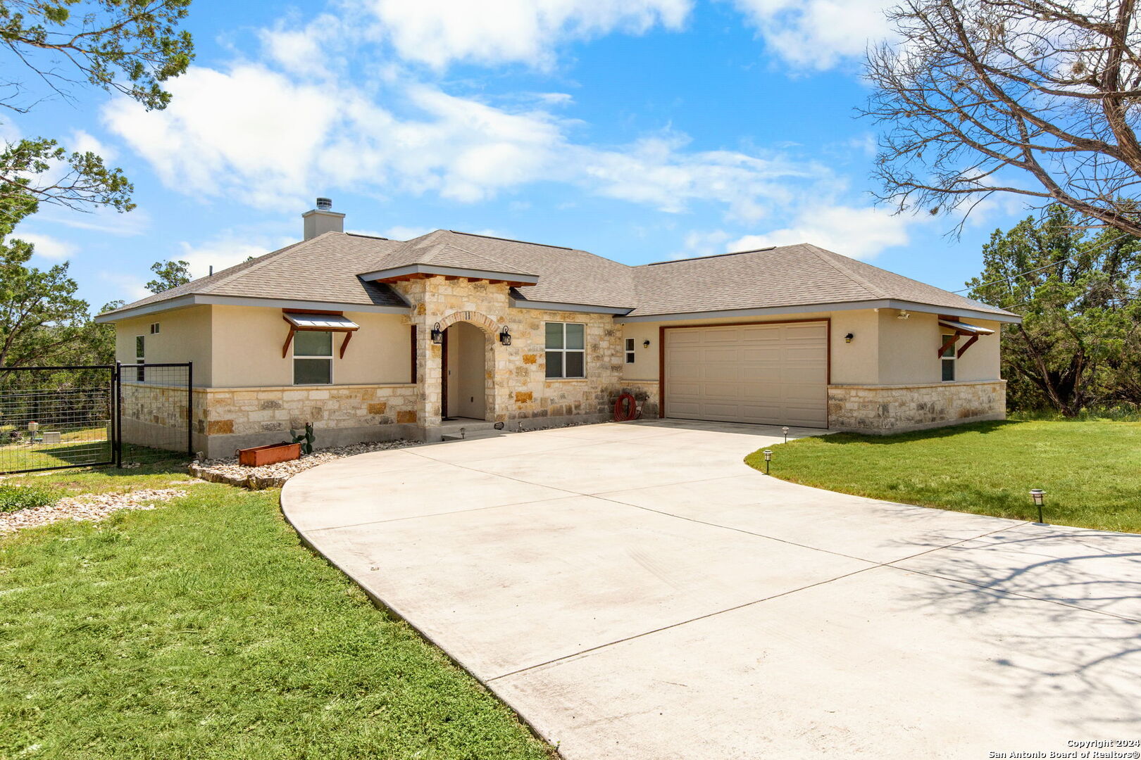 a front view of a house with a garden and yard