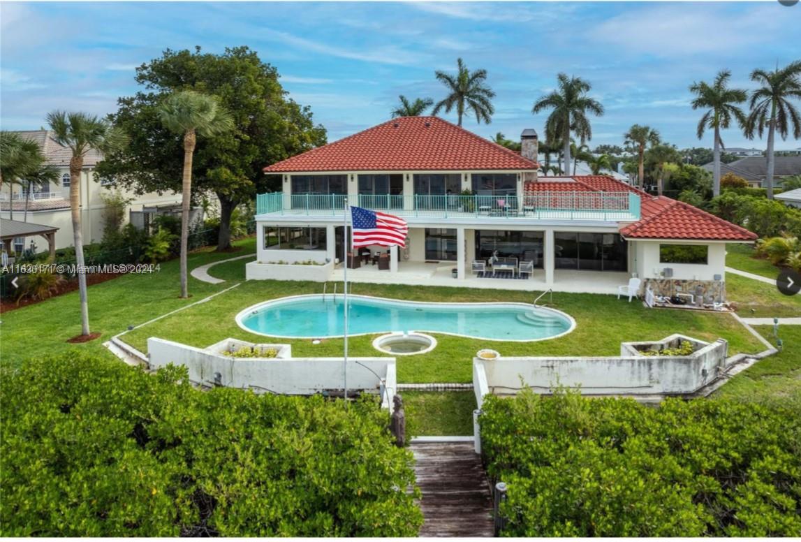 an aerial view of a house with swimming pool patio and outdoor seating