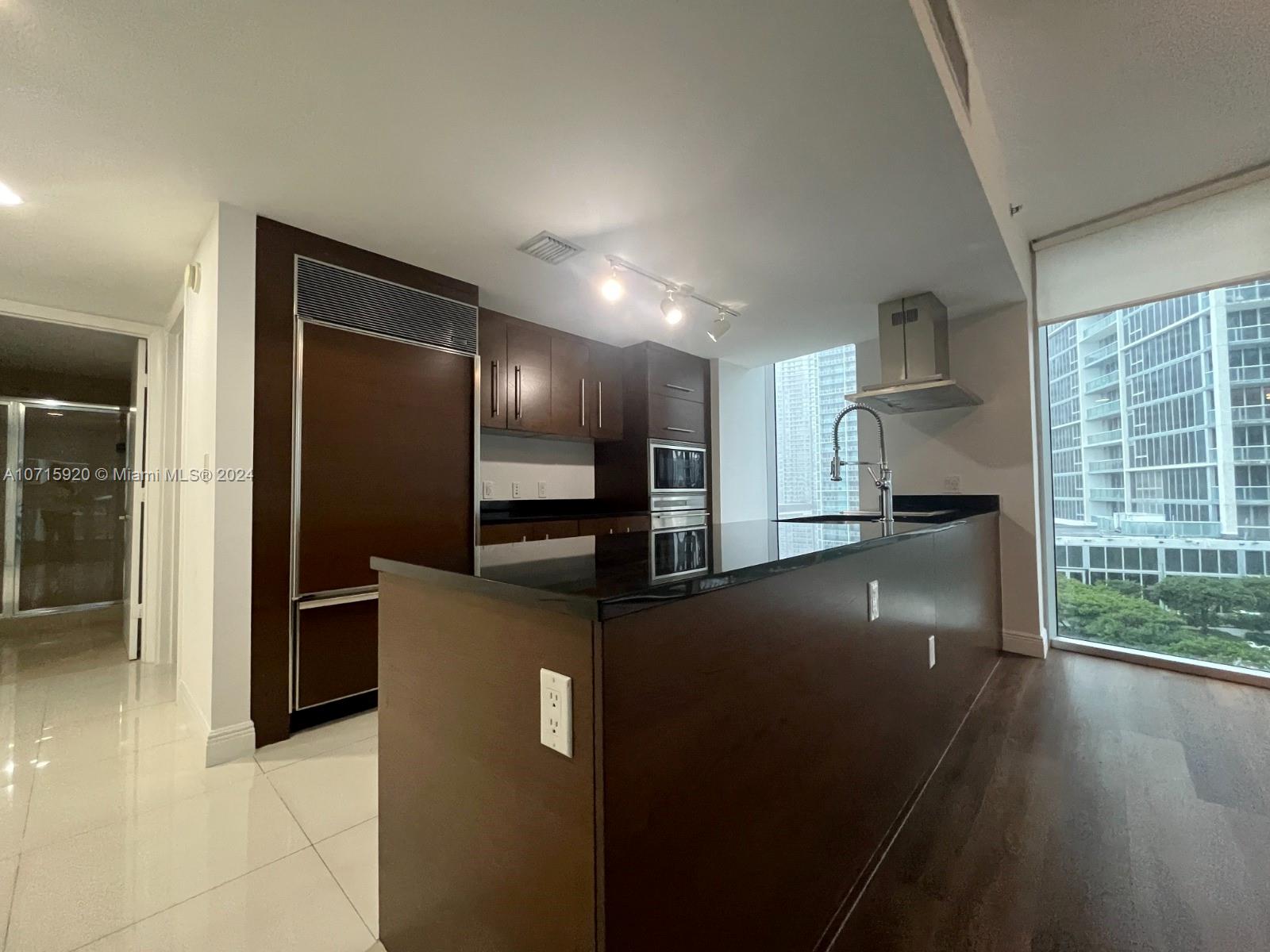 a kitchen with stainless steel appliances a refrigerator and a sink