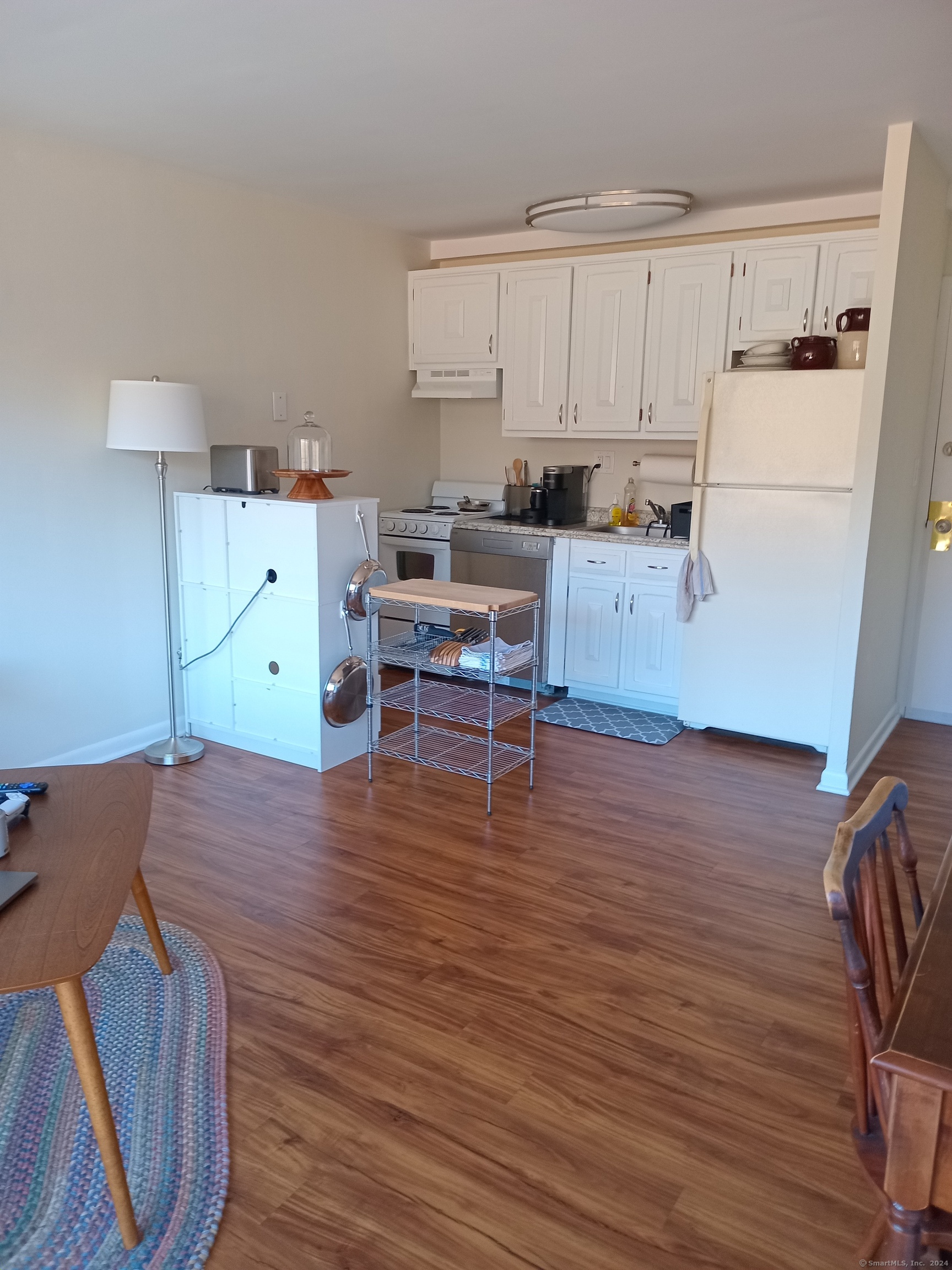 a kitchen with stainless steel appliances wooden floors and wooden cabinets