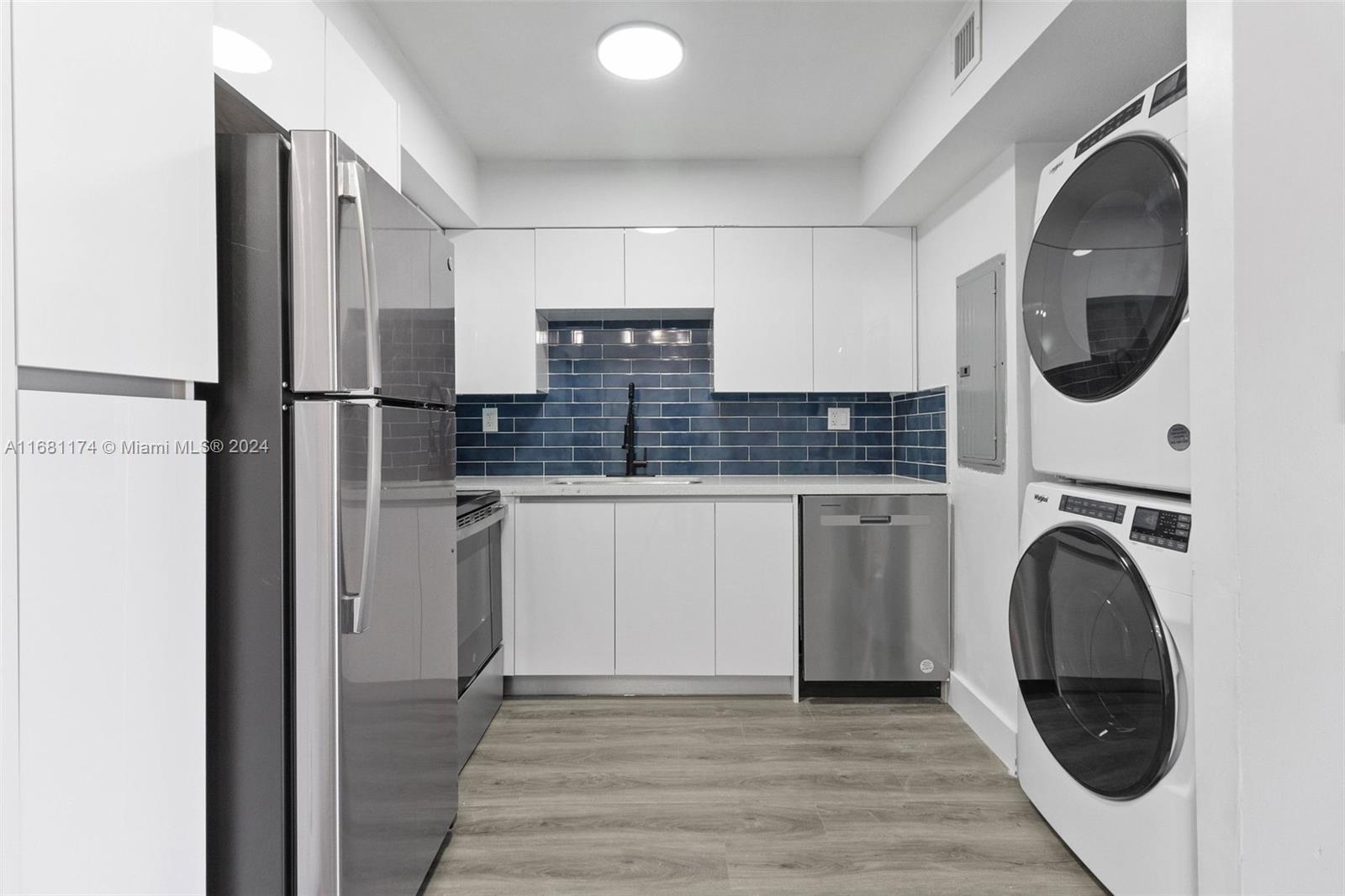 a kitchen with kitchen island a stove a refrigerator and a sink