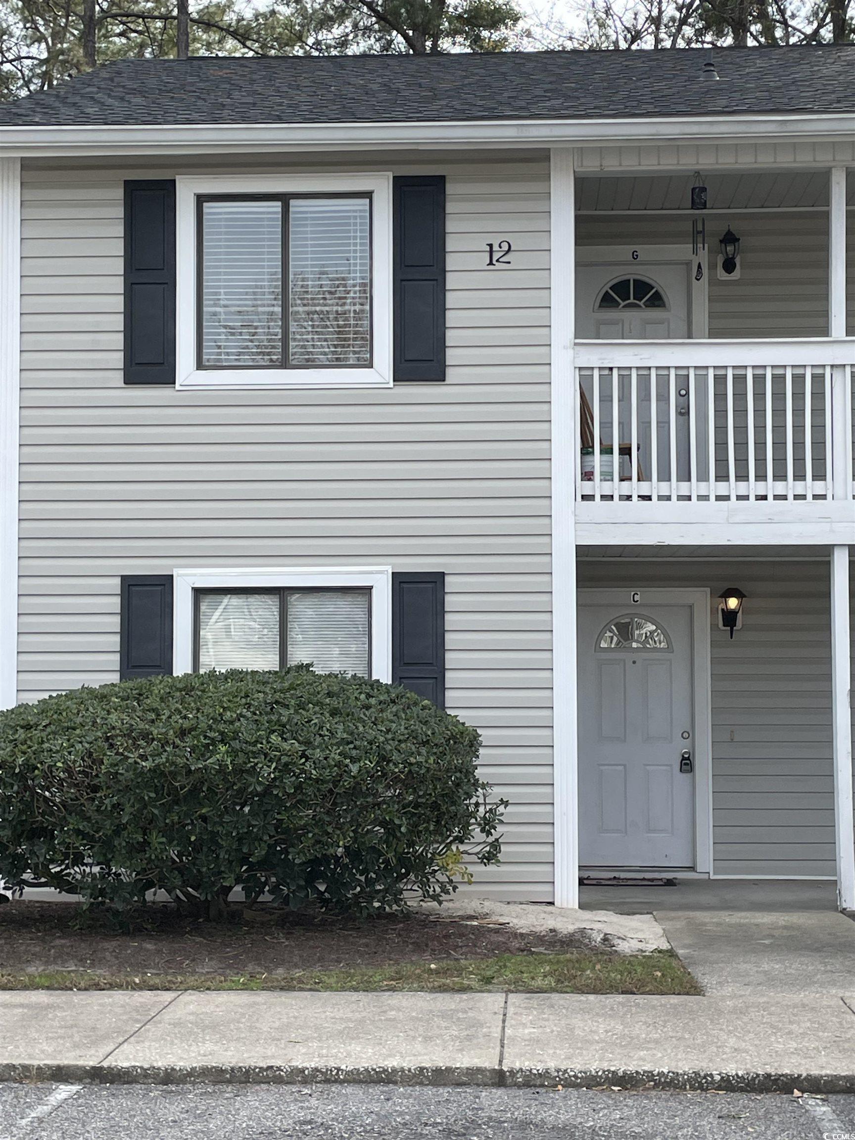 View of front of property with a balcony