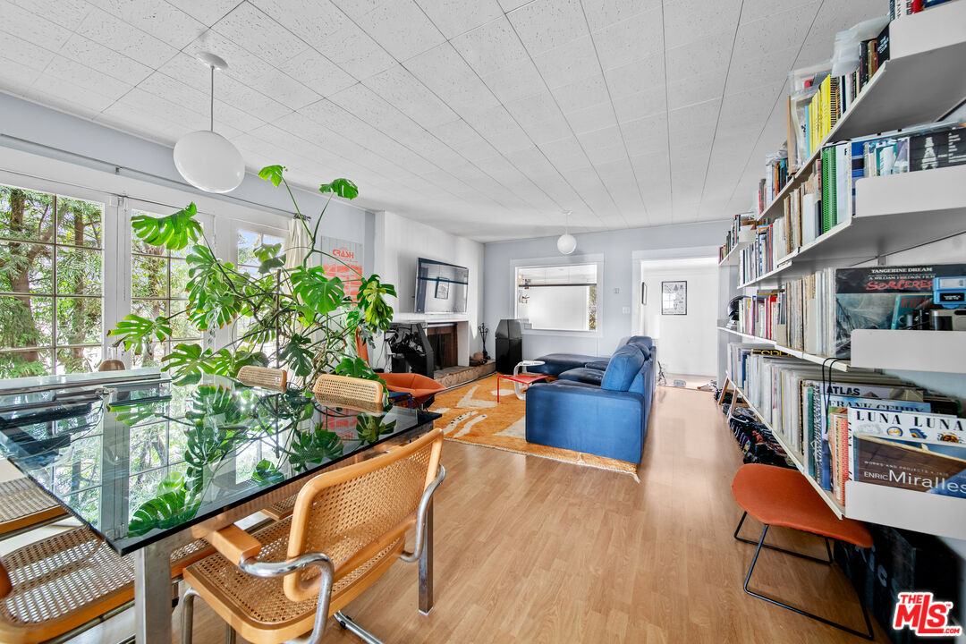 a living room with furniture fireplace and a large window