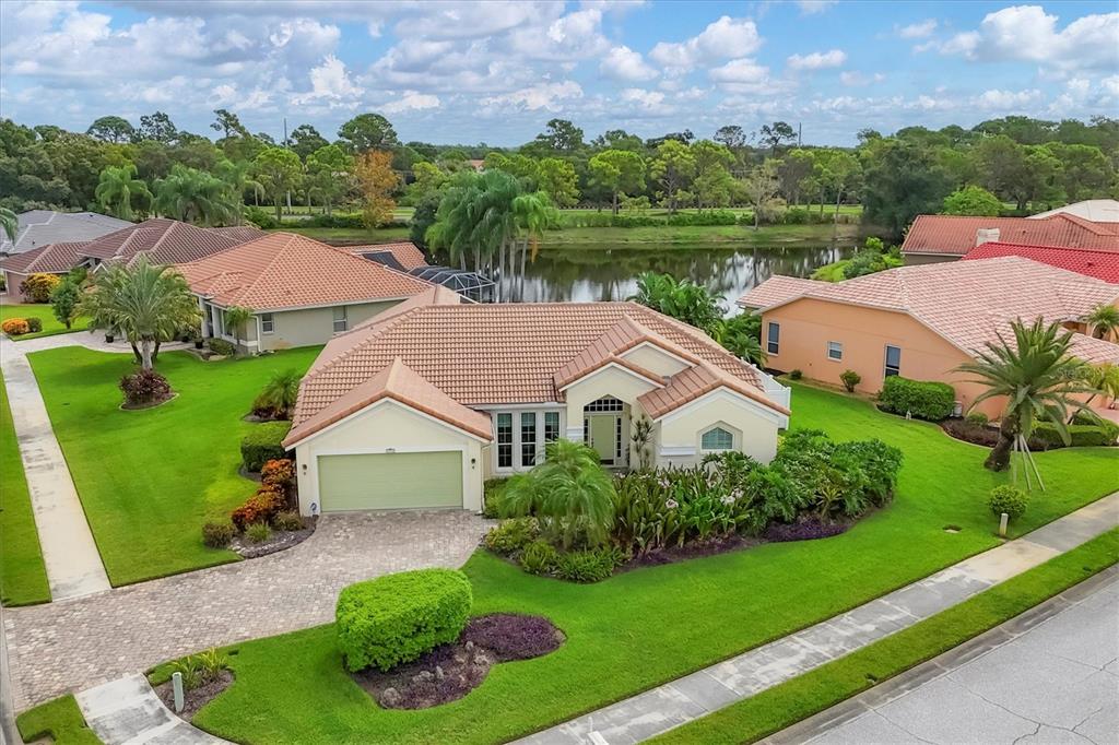 an aerial view of house with yard and lake view