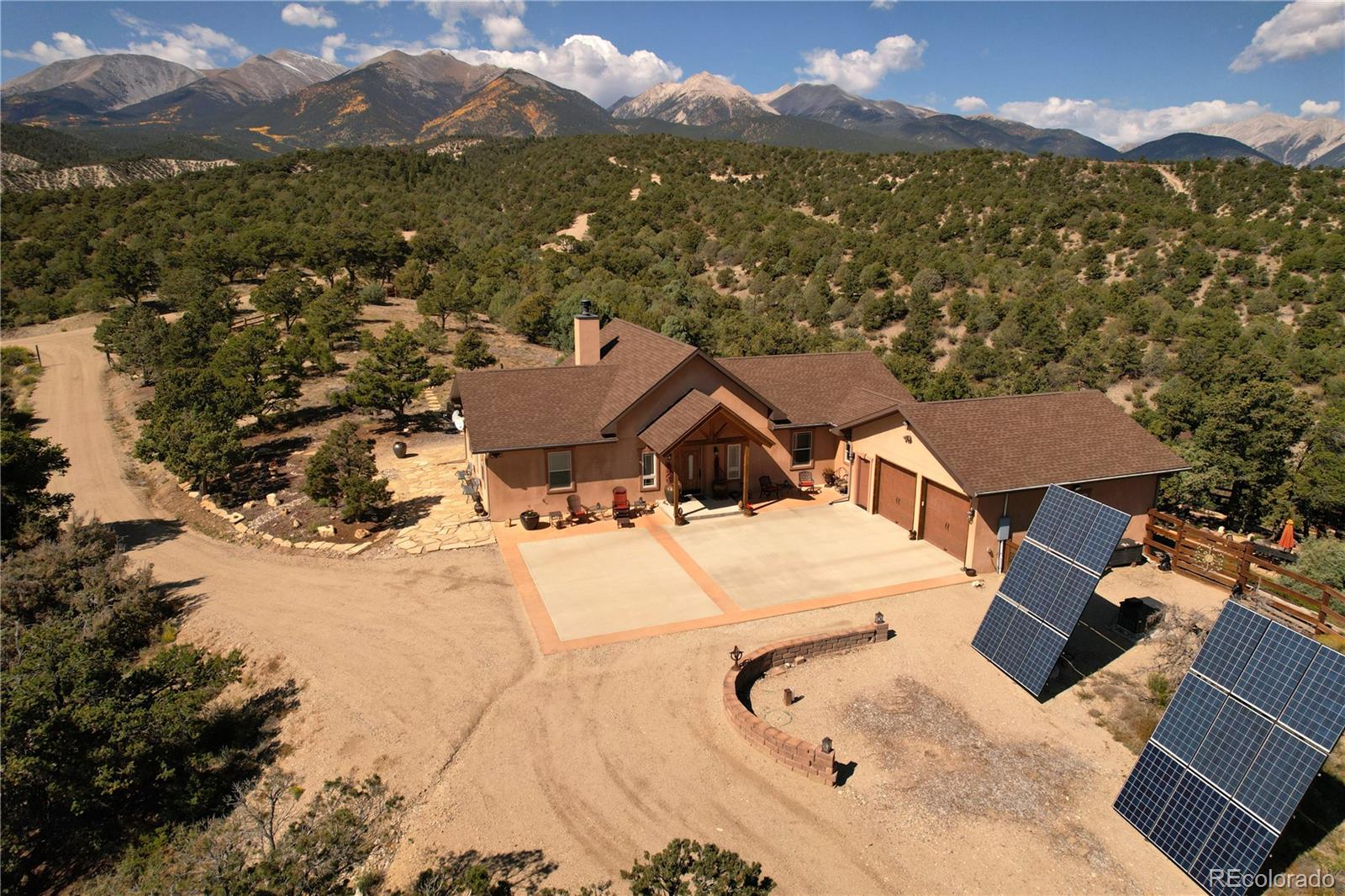 an aerial view of a house with a mountain