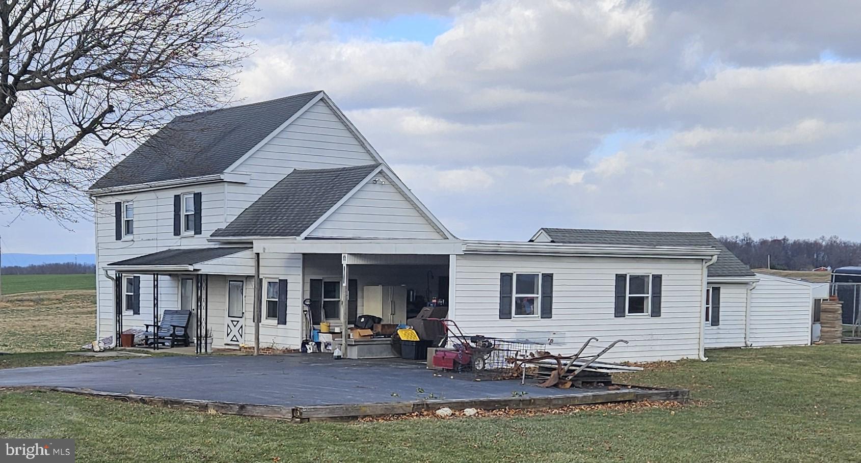 a view of a house with backyard porch and sitting area