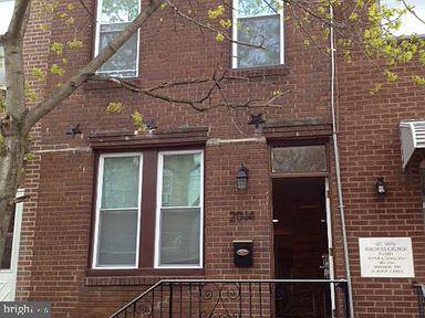 a view of a brick house with a large window